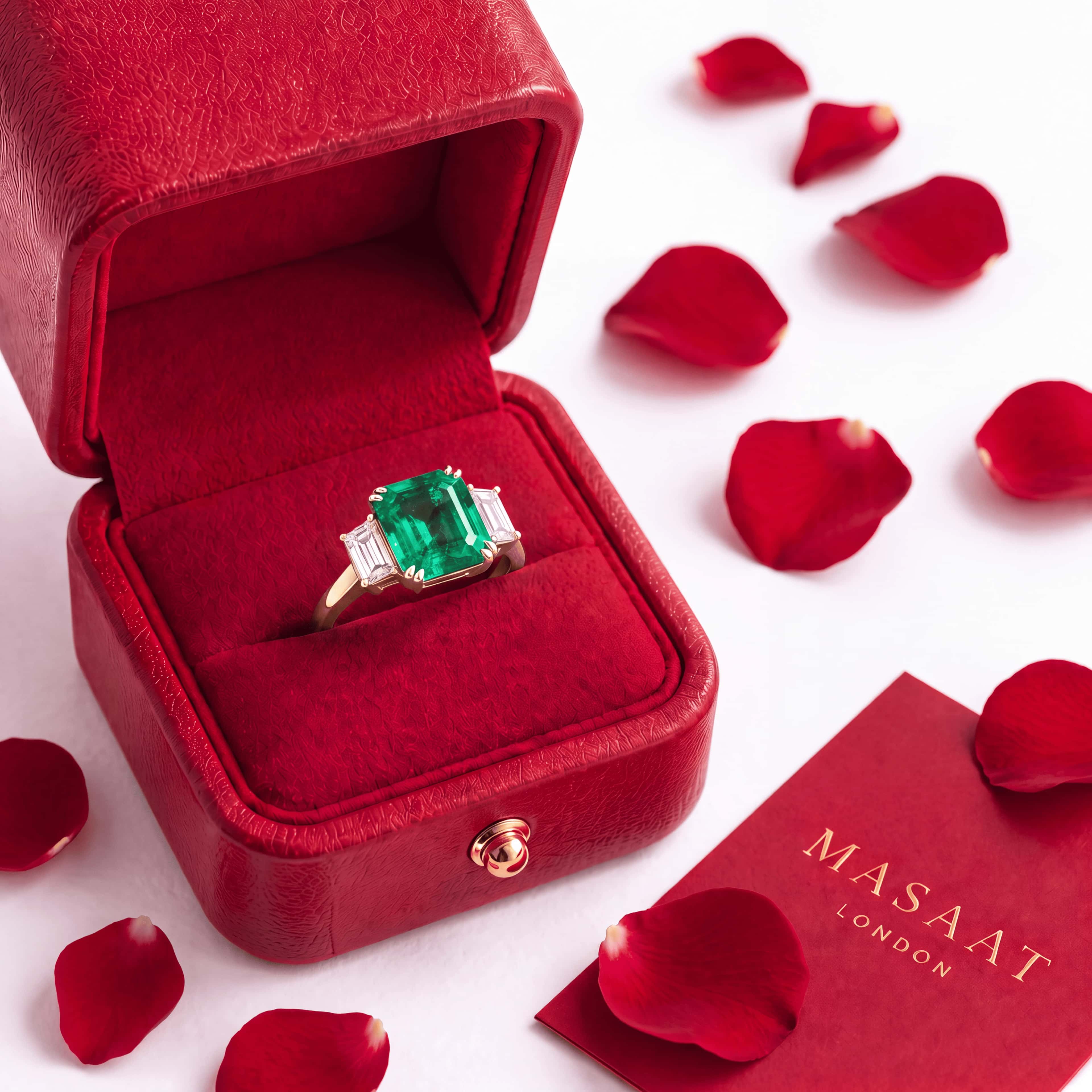 A ring stored in a red Masaat London gift box with rose petals