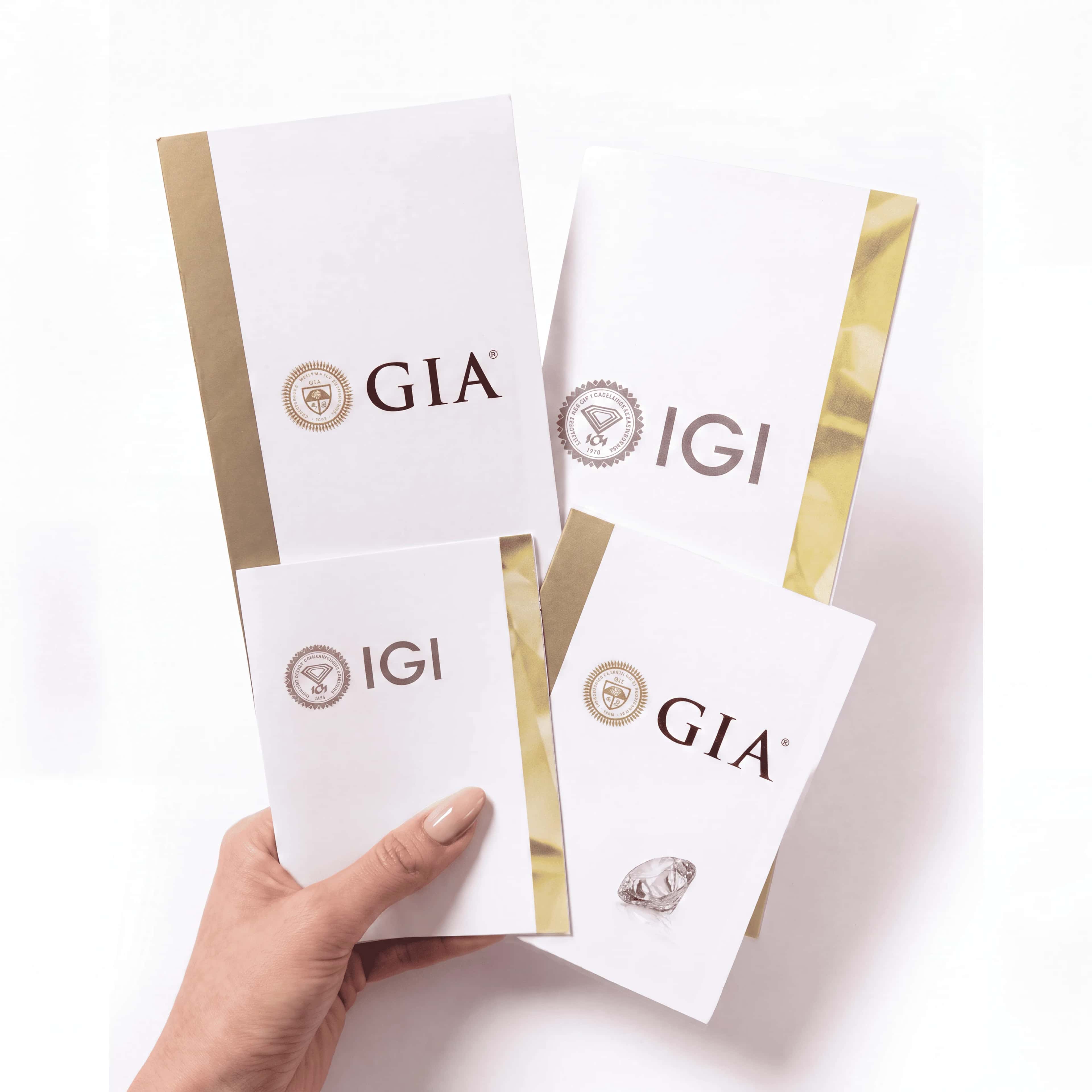 IGI and GIA diamond grading reports held in hand