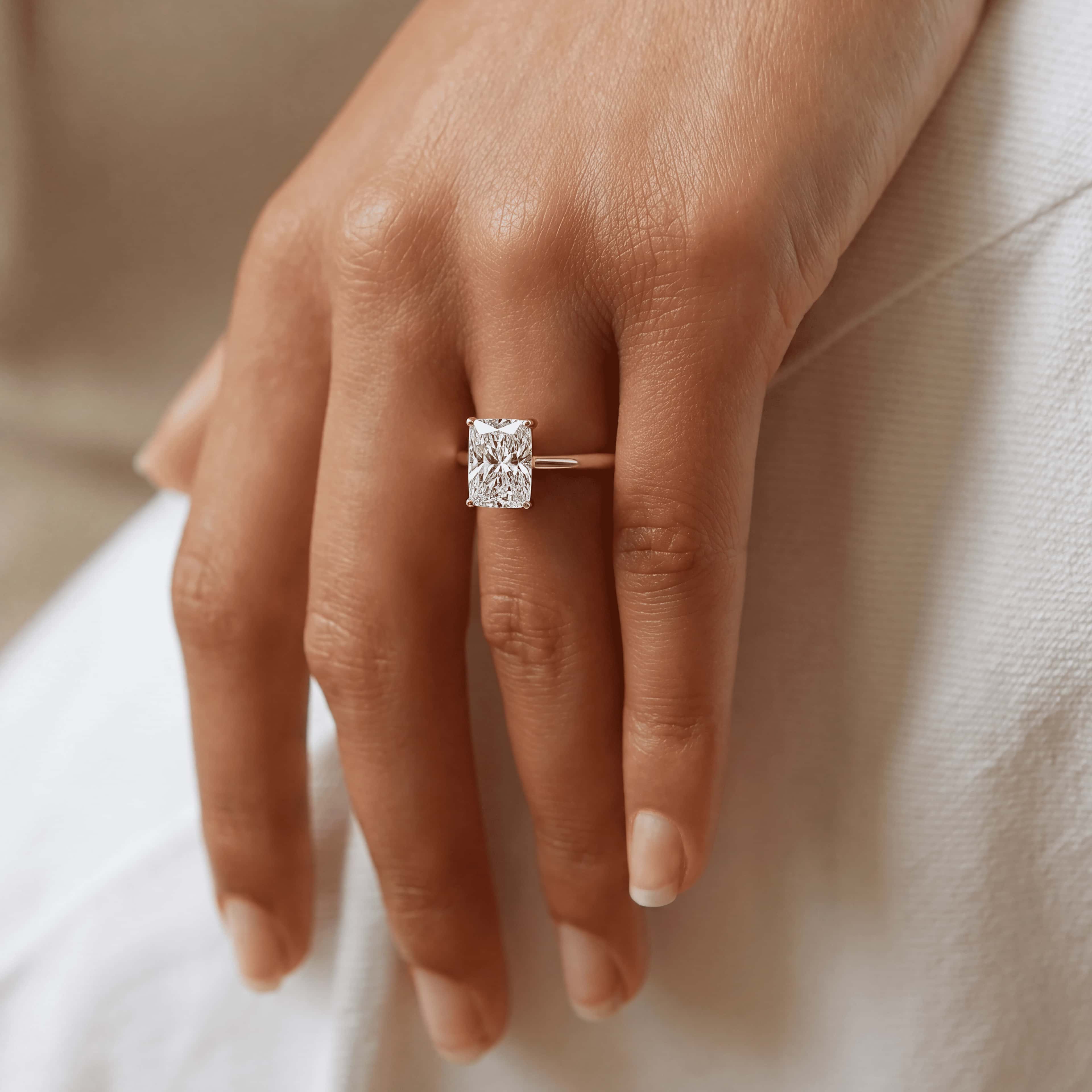 Radiant-cut lab-grown diamond solitaire worn on the hand